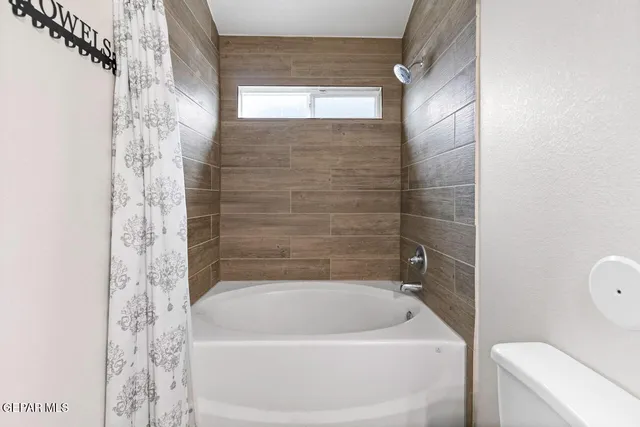 a bath tub sitting next to a white toilet