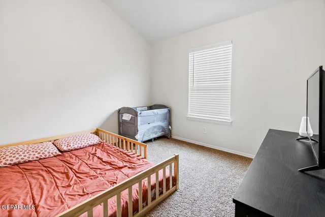 a bedroom with furniture and a window