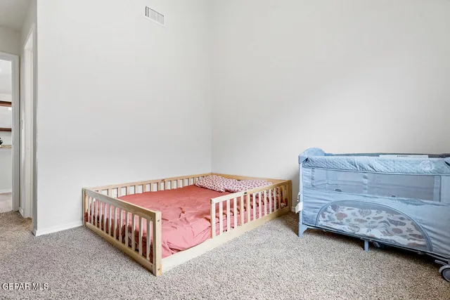 a bedroom with a bed and a dresser