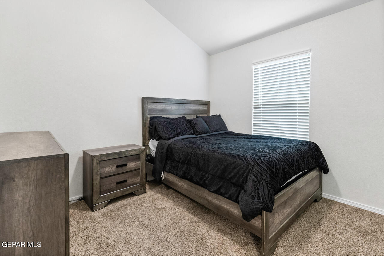 11288 Santa Barbara Socorro, TX 79927 - Photo 23 of 31 a bed sitting in a bedroom next to a window with dresser