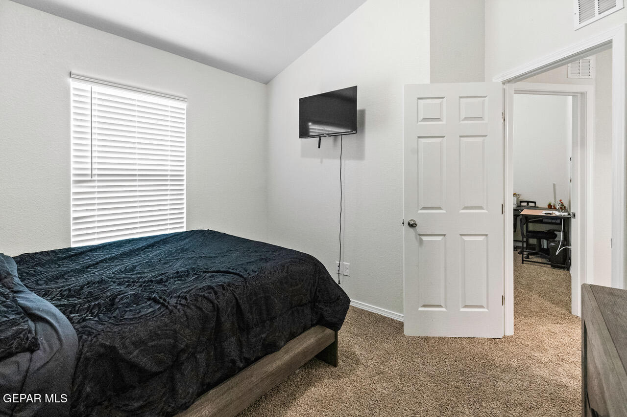 11288 Santa Barbara Socorro, TX 79927 - Photo 24 of 31 a bedroom with a bed and a flat screen tv