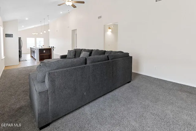 a living room with furniture and a mirror