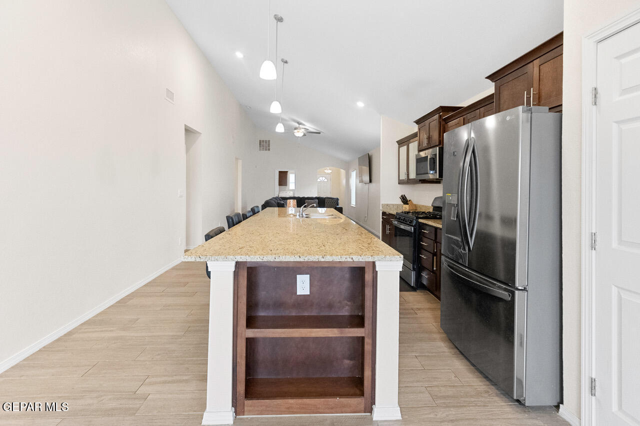 11288 Santa Barbara Socorro, TX 79927 - Photo 10 of 31 a kitchen with kitchen island a counter top space stainless steel appliances and a counter top space