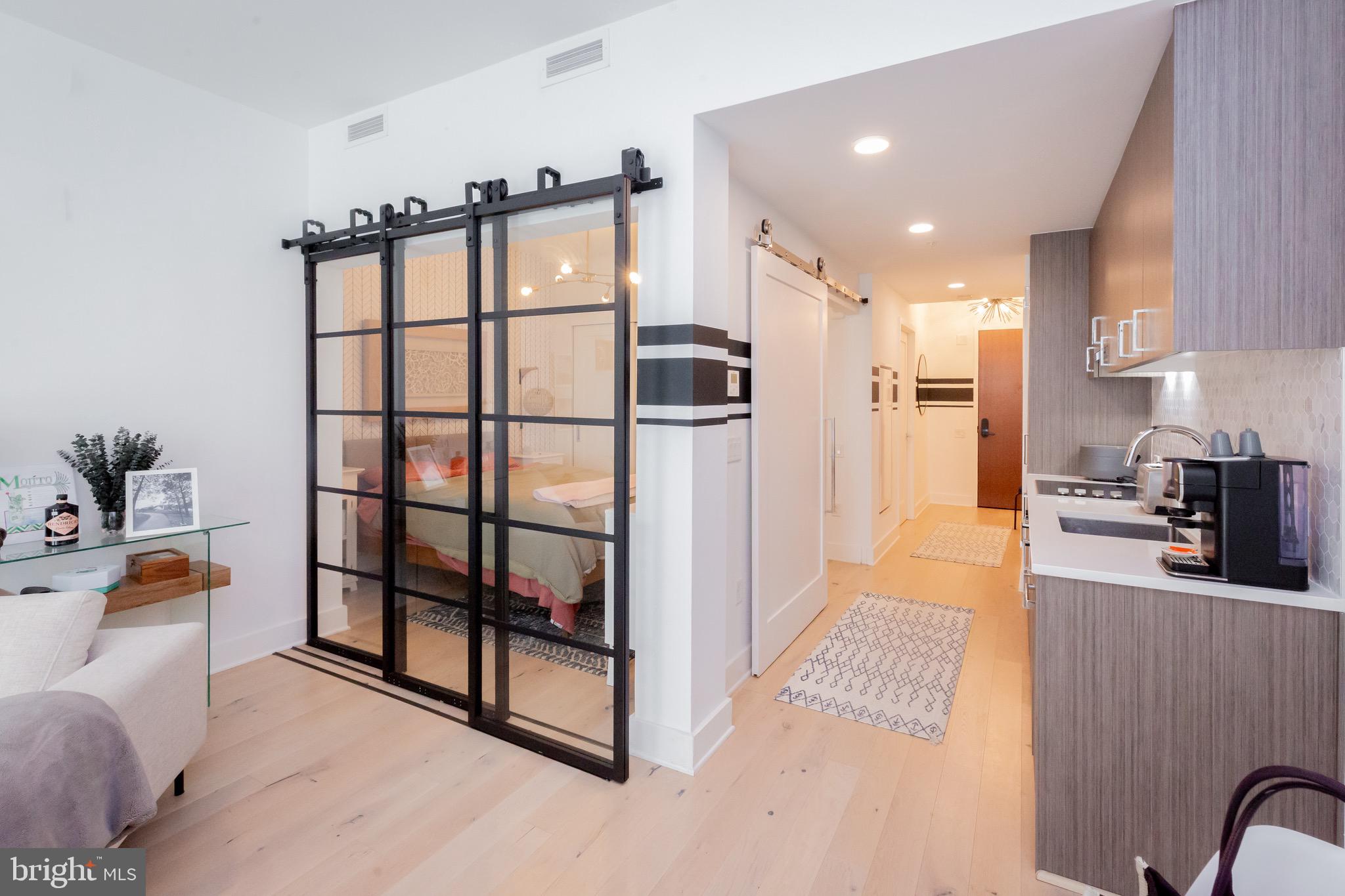 1211 Van Street Southeast, Unit 1210 Washington, DC 20003 - Photo 6 of 42 a kitchen with stainless steel appliances granite countertop a refrigerator and a stove top oven