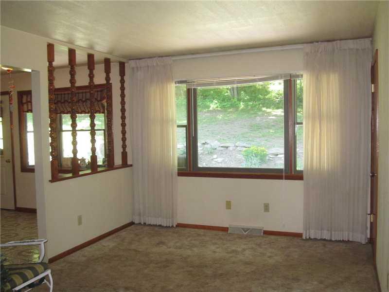 1553 Buffenmeyer Road Latrobe, PA 15650 - Photo 19 of 25 Living Room. In-law suite living room, with view to back of property and patio. There is also powder room off living area.