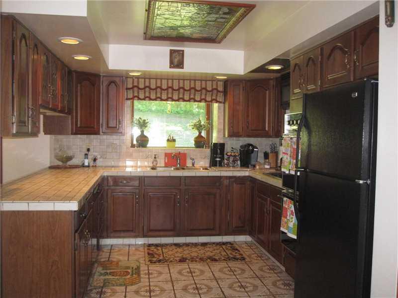 1553 Buffenmeyer Road Latrobe, PA 15650 - Photo 9 of 25 Kitchen. Fully equipped, 14x20 eat in kitchen comes with double electric convection ovens, electric cooktop, dishwasher, refrigerator and microwave. Plus a garden window to enjoy the view of the woods in back.