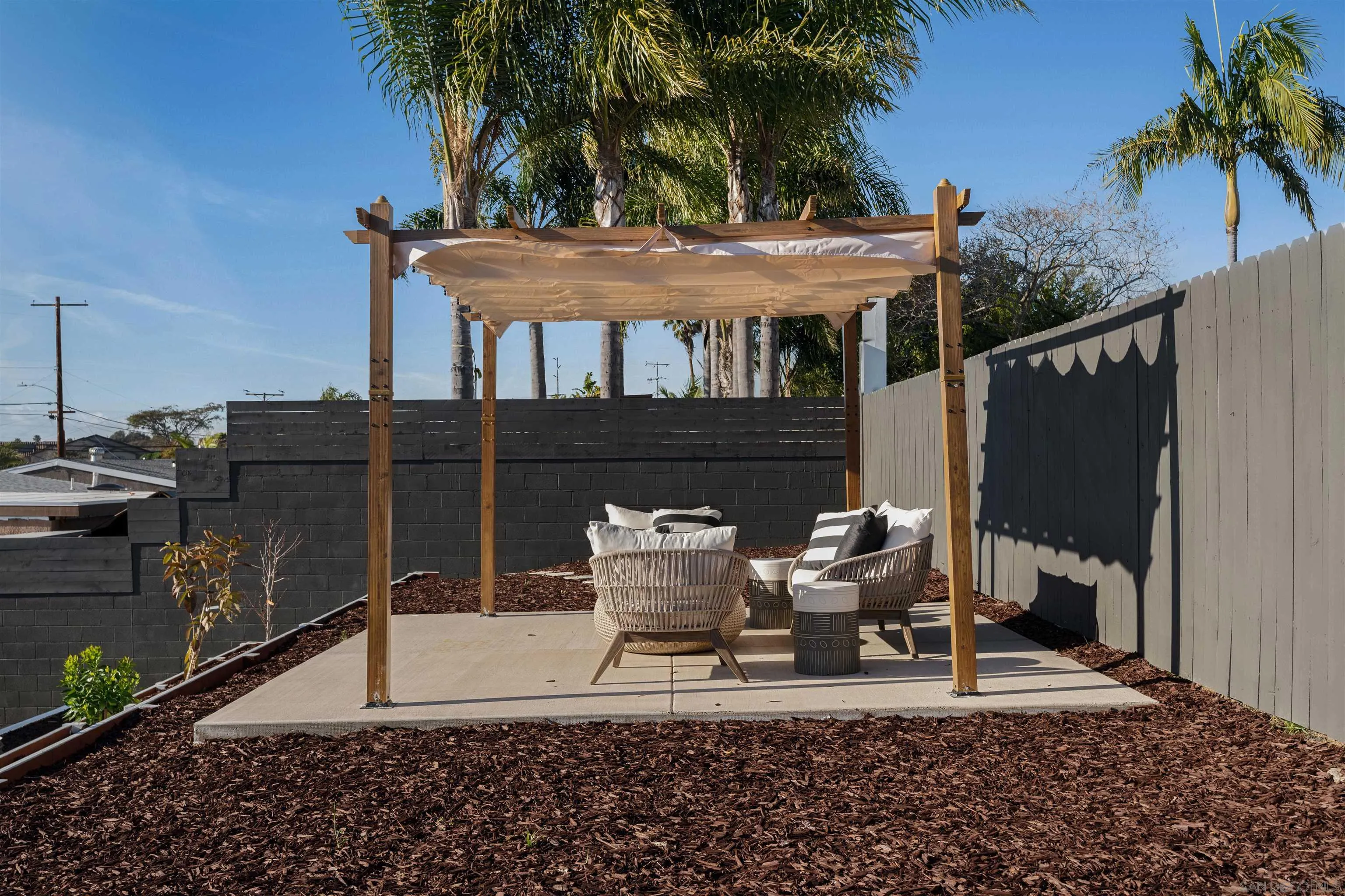 1426 Santa Rosa Street Oceanside, CA 92058 - Photo 65 of 73 a view of a patio with table and chairs potted plants