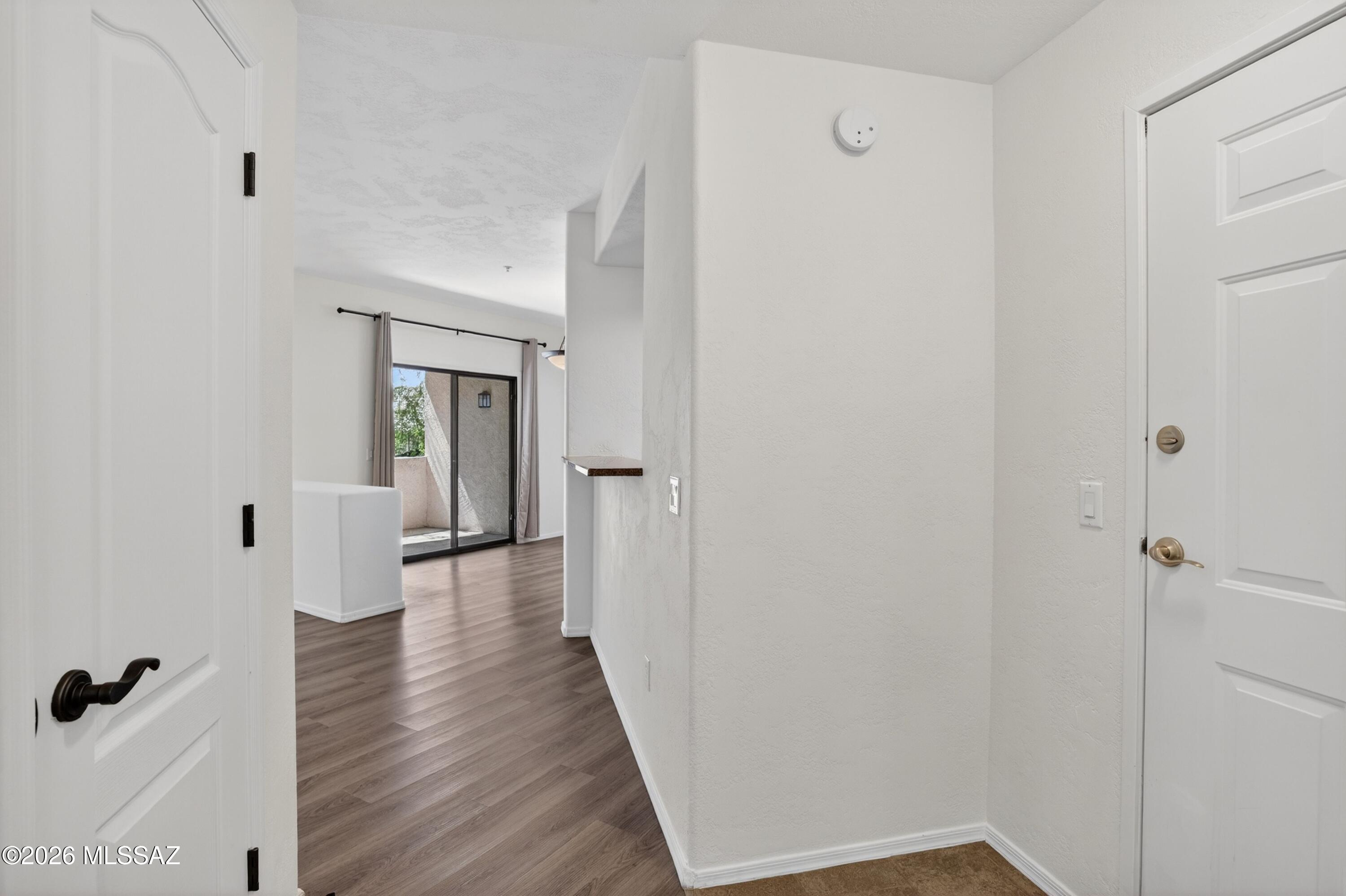 2550 East River Road, Unit 4204 Tucson, AZ 85718 - Photo 3 of 36 a view of a hallway with wooden floor and closet area
