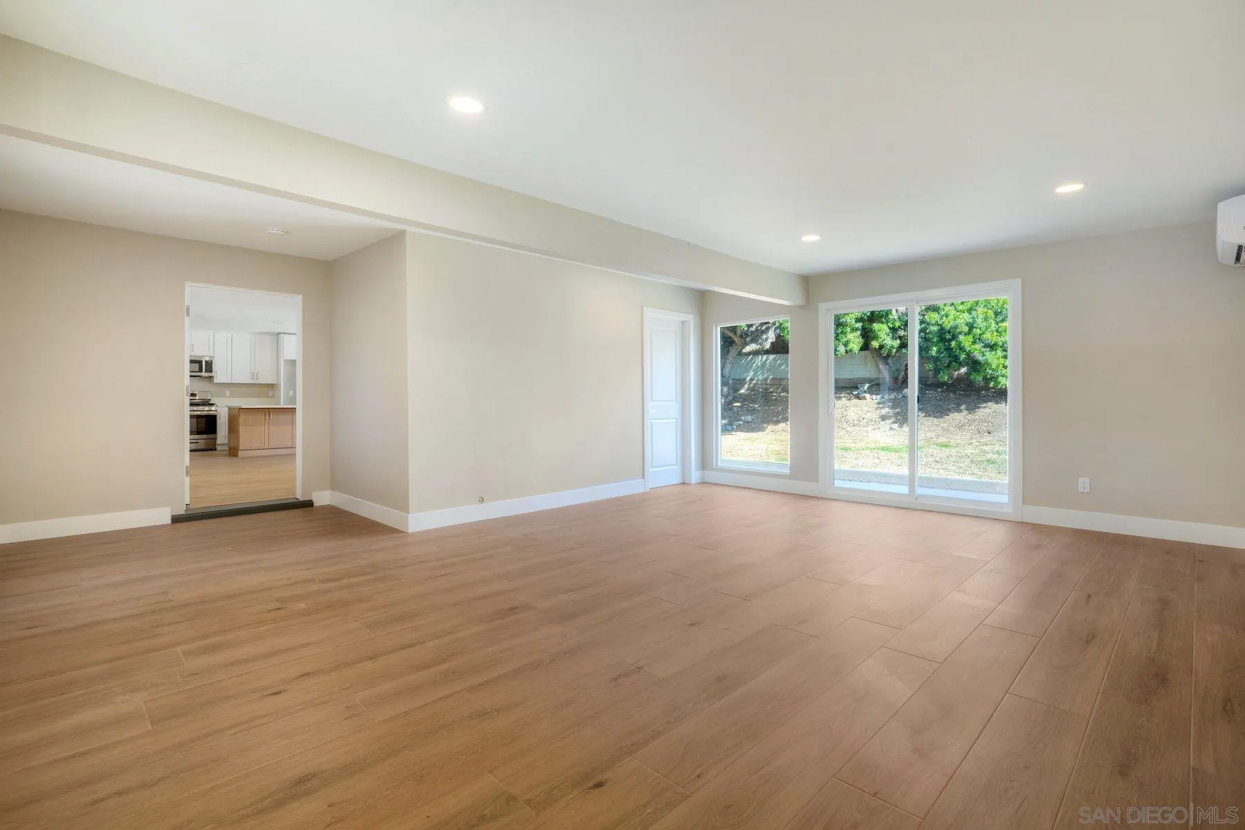 578 East Indian Rock Road Vista, CA 92084 - Photo 5 of 30 a view of an empty room with wooden floor and a window