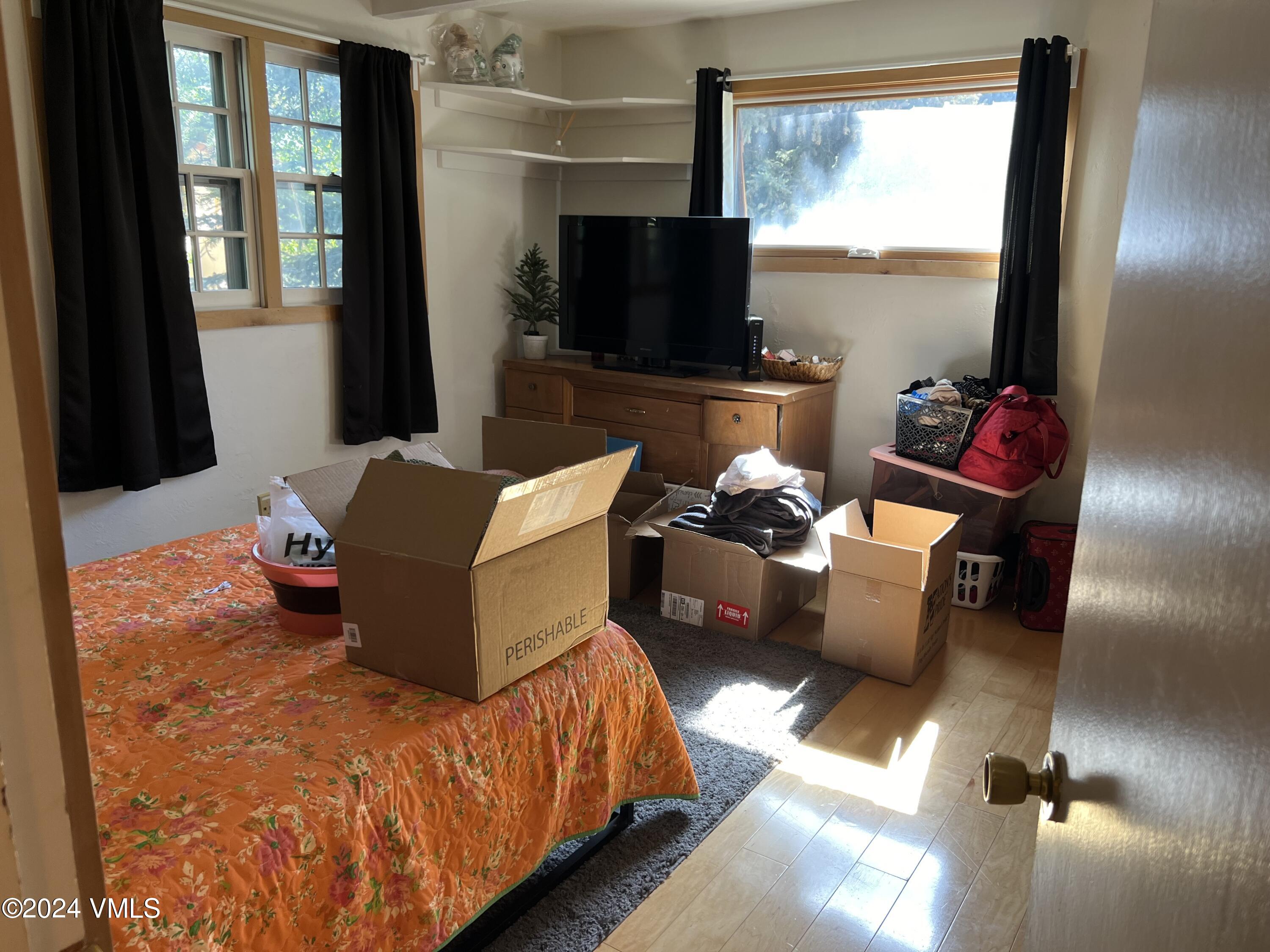 2450 Chamonix Lane, Unit 4 Vail, CO 81657 - Photo 5 of 7 a living room with furniture and a flat screen tv