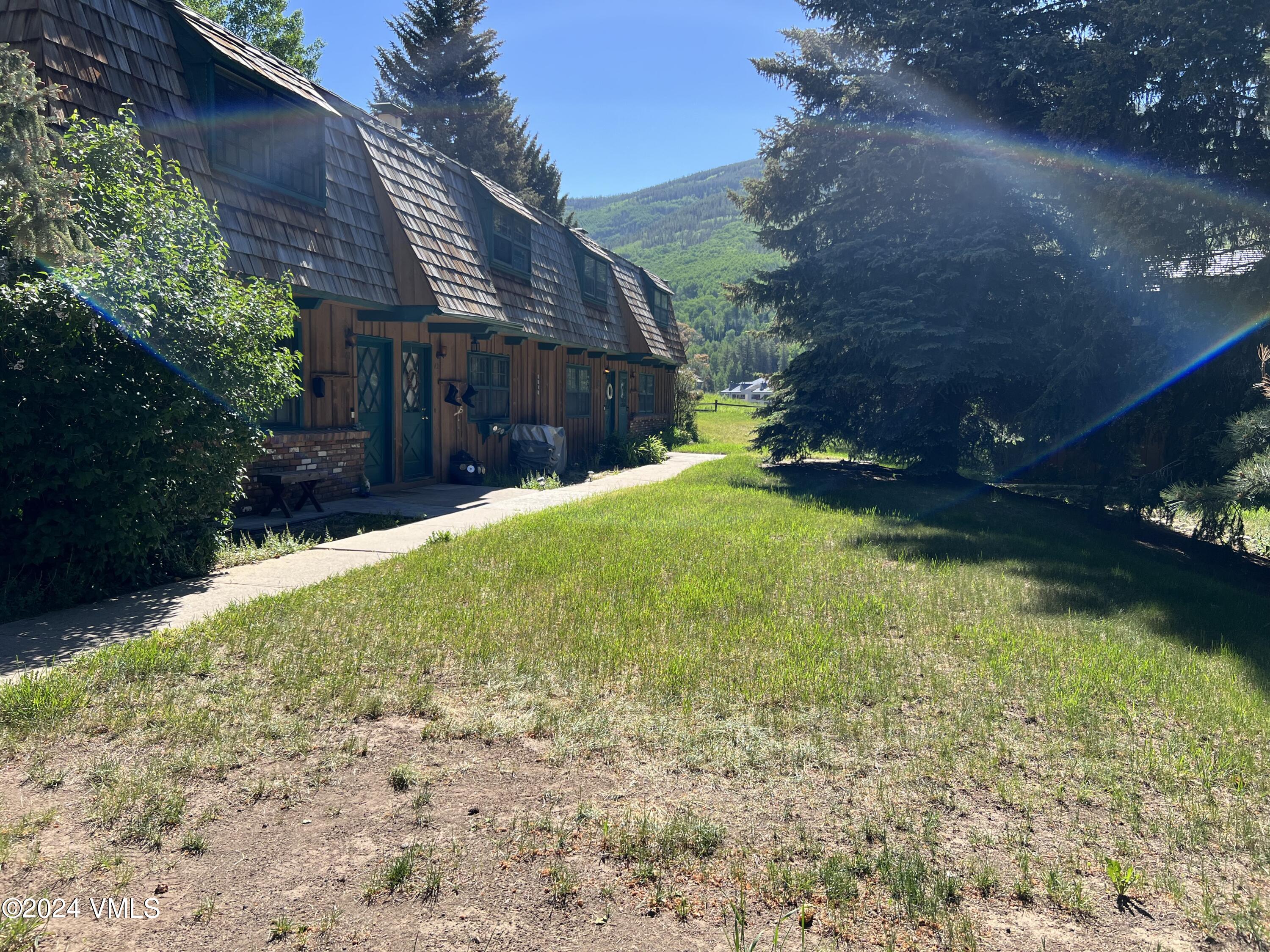 2450 Chamonix Lane, Unit 4 Vail, CO 81657 - Photo 7 of 7 a view of a house with a yard