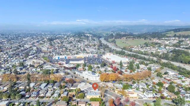an aerial view of residential houses with city view