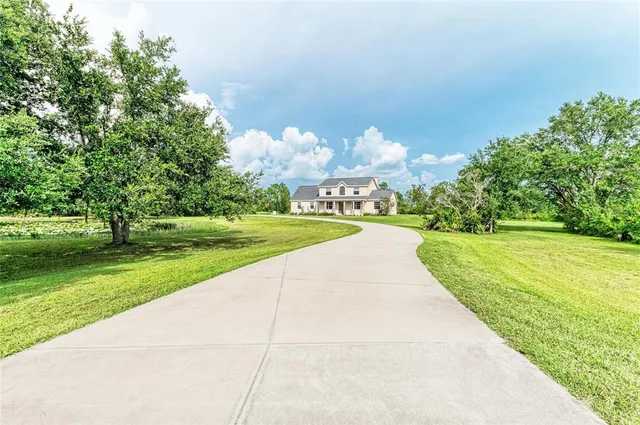 a backyard of a house with a yard and outdoor seating
