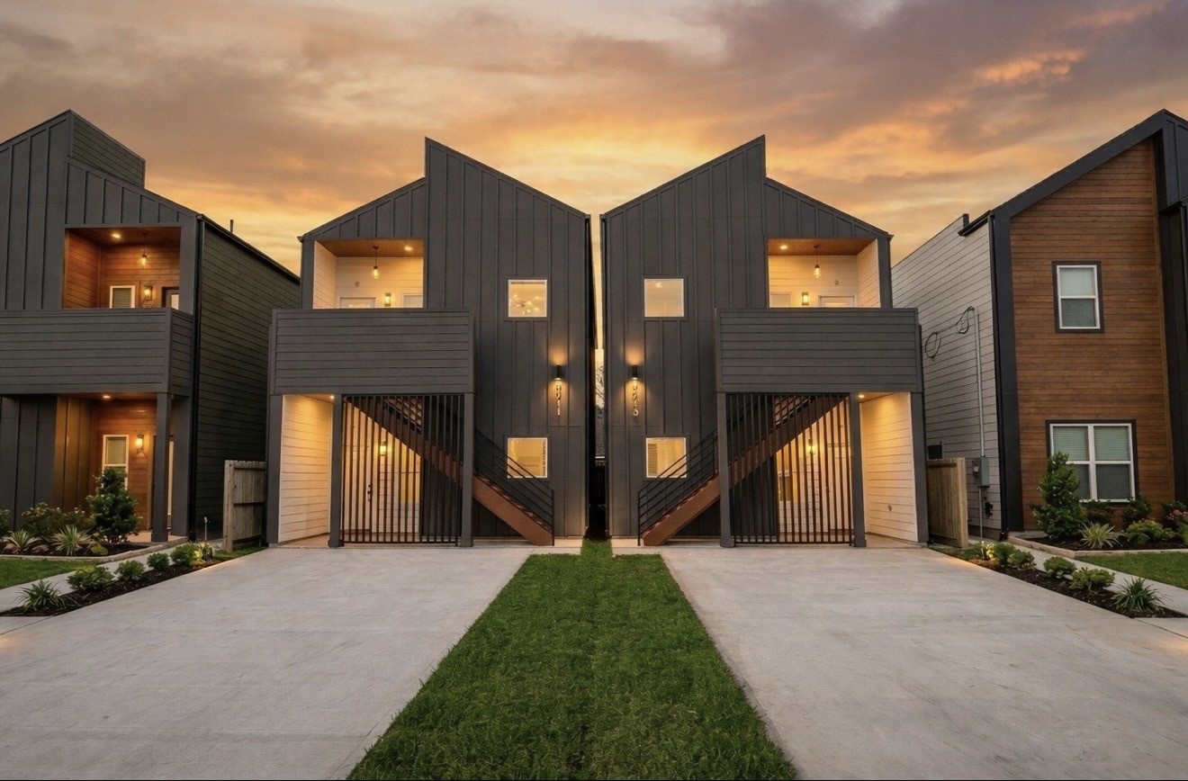 a view of house with yard and glass windows