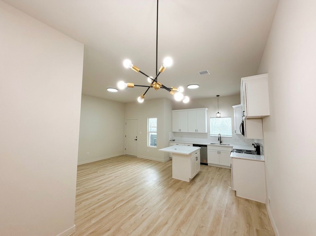 9740 Garcroft Street Houston, TX 77029 - Photo 15 of 17 a view of kitchen with sink and wooden floor