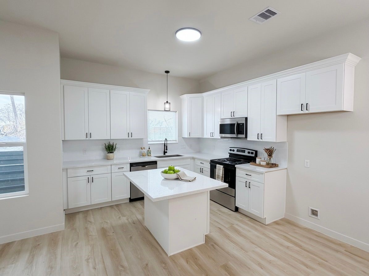 9740 Garcroft Street Houston, TX 77029 - Photo 2 of 17 a kitchen with white cabinets appliances and sink