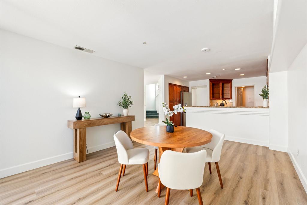 1831 Monserrat Way Vista, CA 92081 - Photo 11 of 46 a dining room with furniture and wooden floor