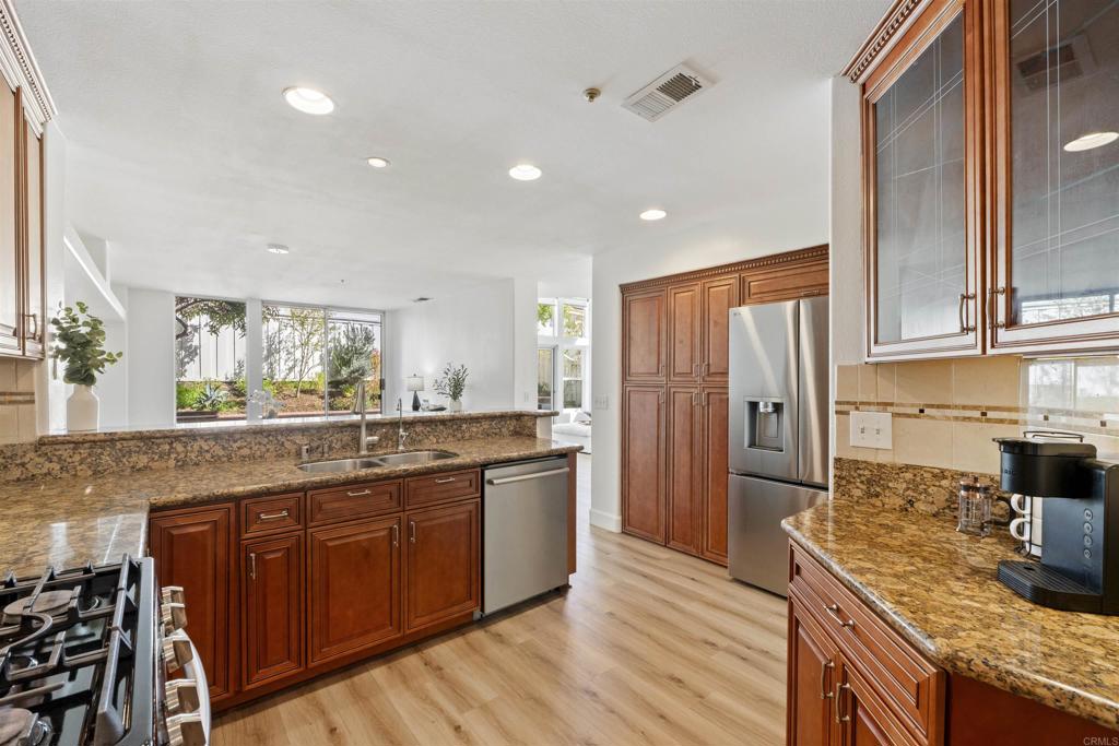 1831 Monserrat Way Vista, CA 92081 - Photo 13 of 46 a kitchen with stainless steel appliances granite countertop counter space a sink and cabinets