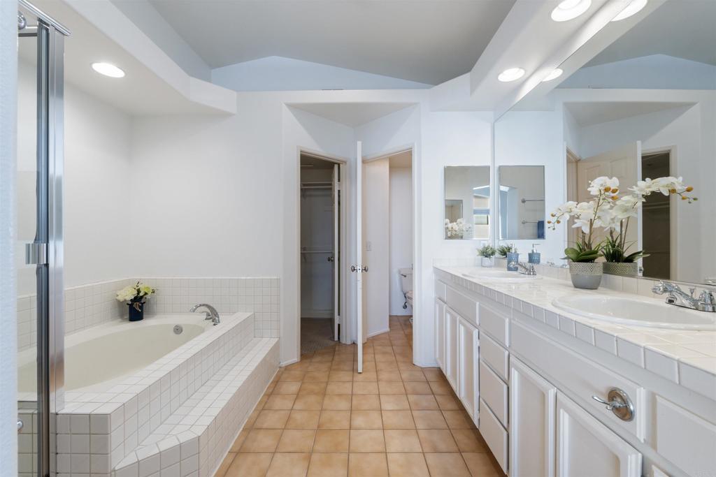 1831 Monserrat Way Vista, CA 92081 - Photo 22 of 46 a spacious bathroom with a tub sink and mirror