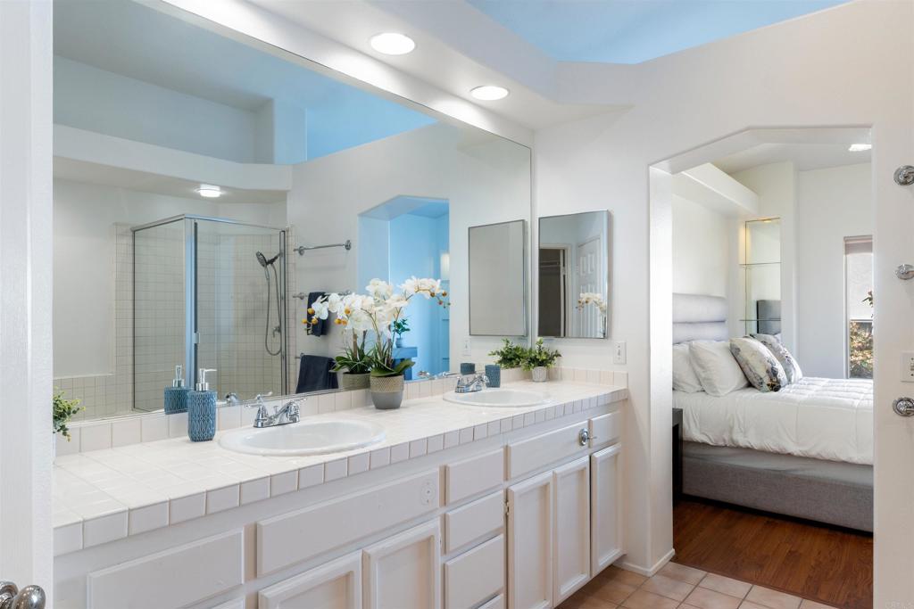 1831 Monserrat Way Vista, CA 92081 - Photo 23 of 46 a en suite bathroom with double sink and a mirror