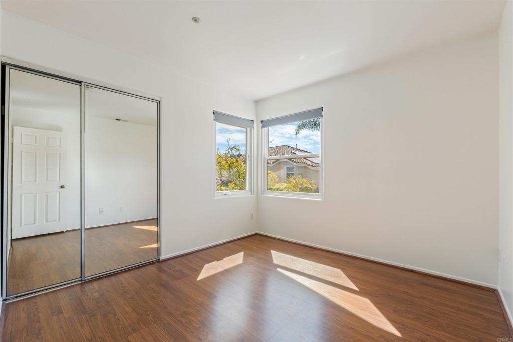 1831 Monserrat Way Vista, CA 92081 - Photo 25 of 46 a view of an empty room with window and wooden floor