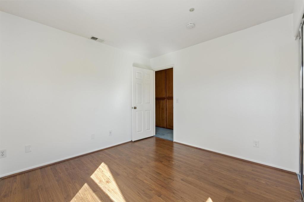 1831 Monserrat Way Vista, CA 92081 - Photo 26 of 46 a view of an empty room with wooden floor