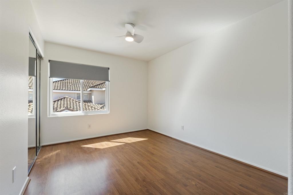 1831 Monserrat Way Vista, CA 92081 - Photo 30 of 46 an empty room with wooden floor and windows