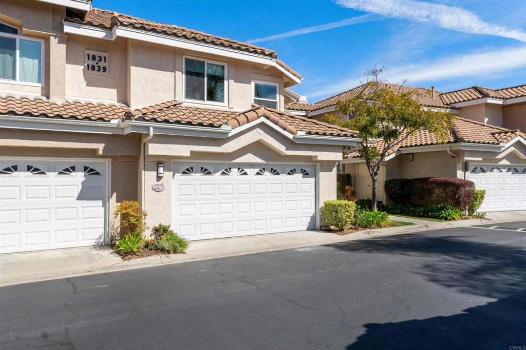 1831 Monserrat Way Vista, CA 92081 - Photo 3 of 46 a front view of a house with a yard and garage