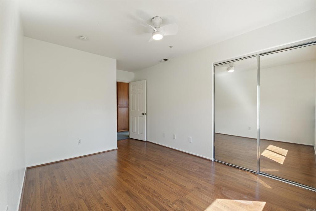 1831 Monserrat Way Vista, CA 92081 - Photo 31 of 46 wooden floor in an empty room with a window
