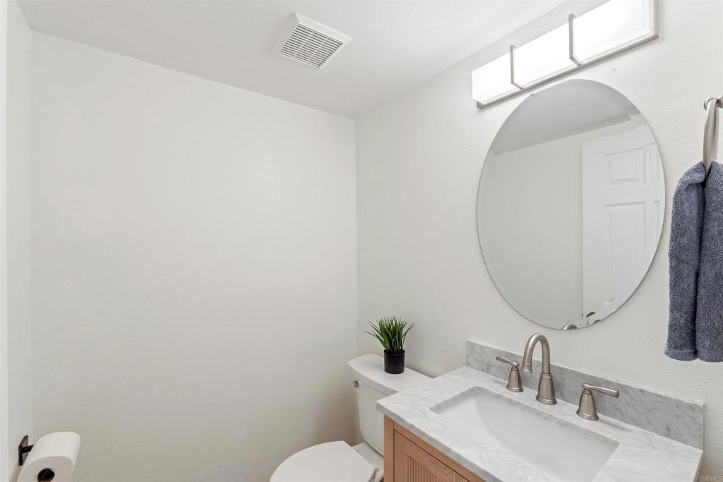 1831 Monserrat Way Vista, CA 92081 - Photo 33 of 46 a bathroom with a sink and a mirror