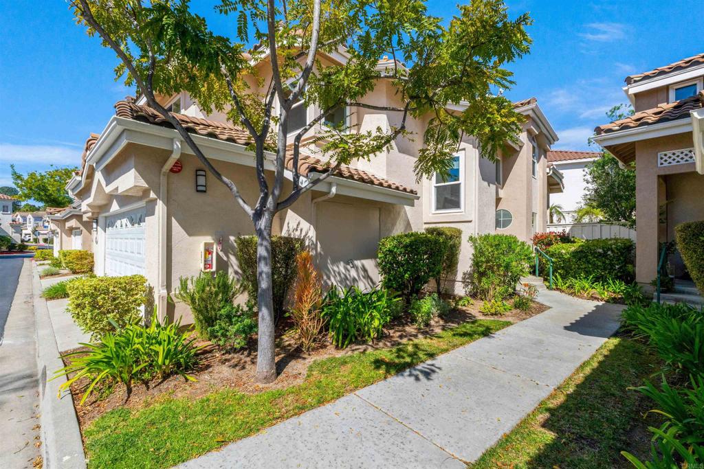 1831 Monserrat Way Vista, CA 92081 - Photo 4 of 46 a front view of a house with a yard