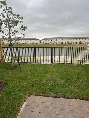 a view of a yard with wooden fence