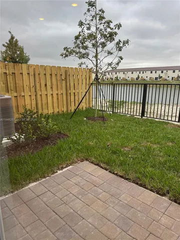 a view of a backyard with wooden fence