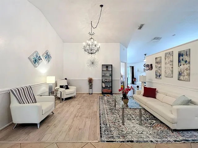 a living room with furniture or couch and a chandelier