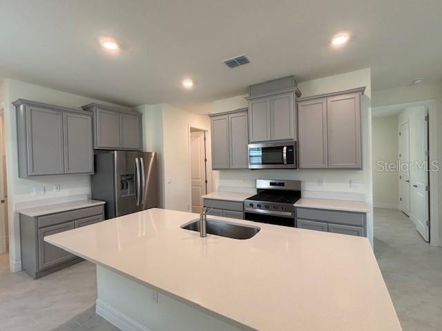 3969 Kennebunk Loop Mount Dora, FL 32757 - Photo 2 of 9 a kitchen with kitchen island a sink stainless steel appliances and cabinets