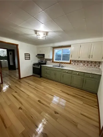 a kitchen with stainless steel appliances granite countertop a stove and a sink
