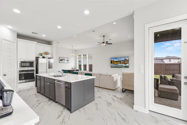 a kitchen with stainless steel appliances granite countertop a stove oven and a refrigerator with cabinets