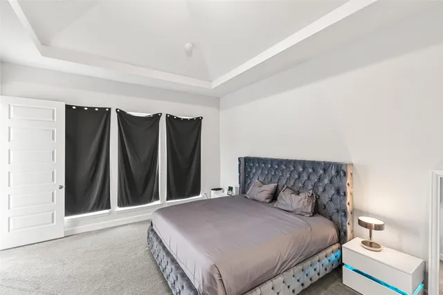 a bedroom with a bed and a mirror