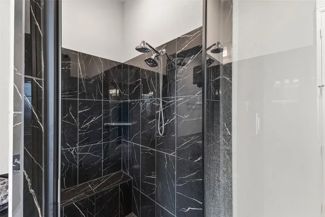 a bathroom with a shower and a mirror