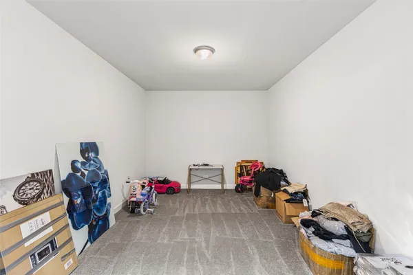 an empty room with closet and windows