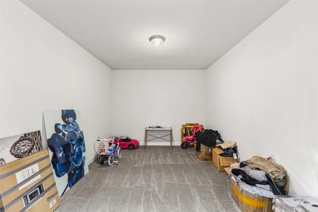 an empty room with closet and windows