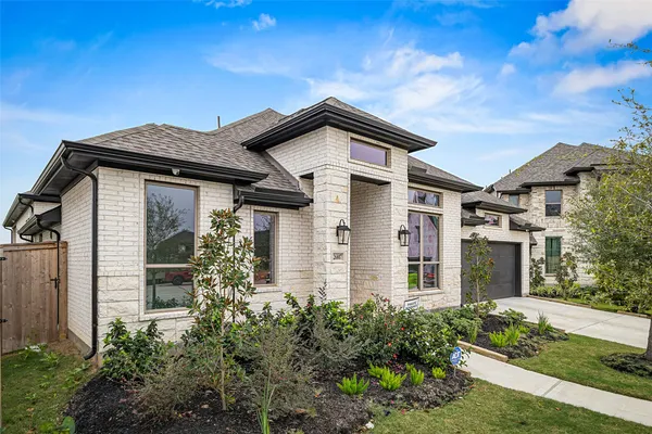 a front view of a house with garden