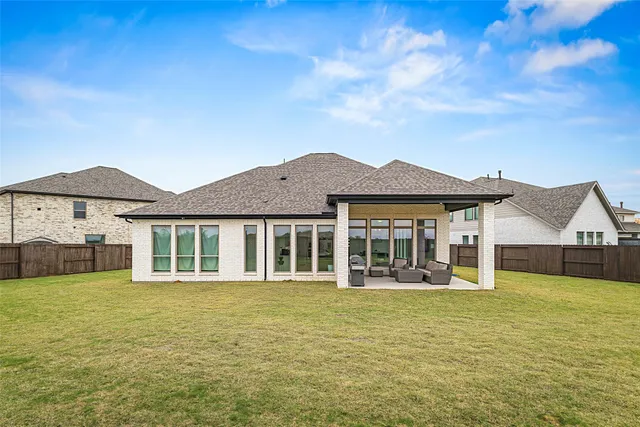 a view of a house with a yard and sitting area