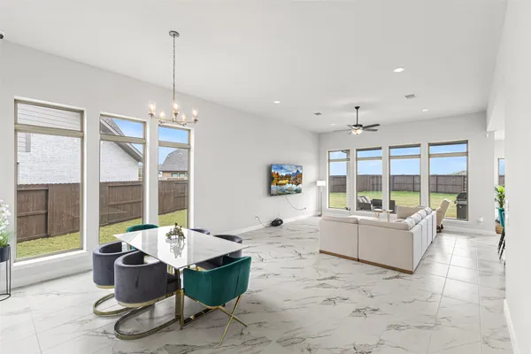 a living room with furniture and large windows