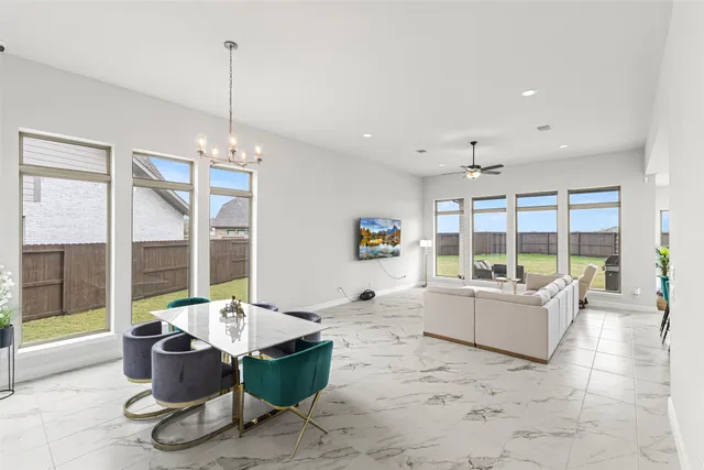 a living room with furniture and large windows