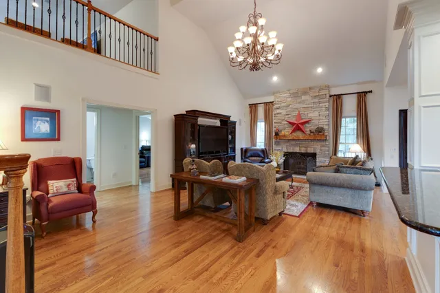 a living room with fireplace furniture and a wooden floor