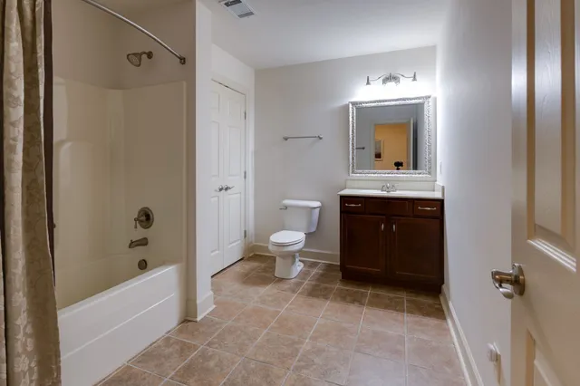 a spacious bathroom with a toilet sink and shower
