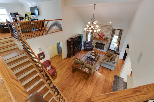 a living room with furniture fireplace and a chandelier