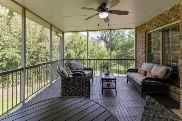 a living room with furniture and a floor to ceiling window