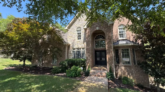 a front view of a house with garden